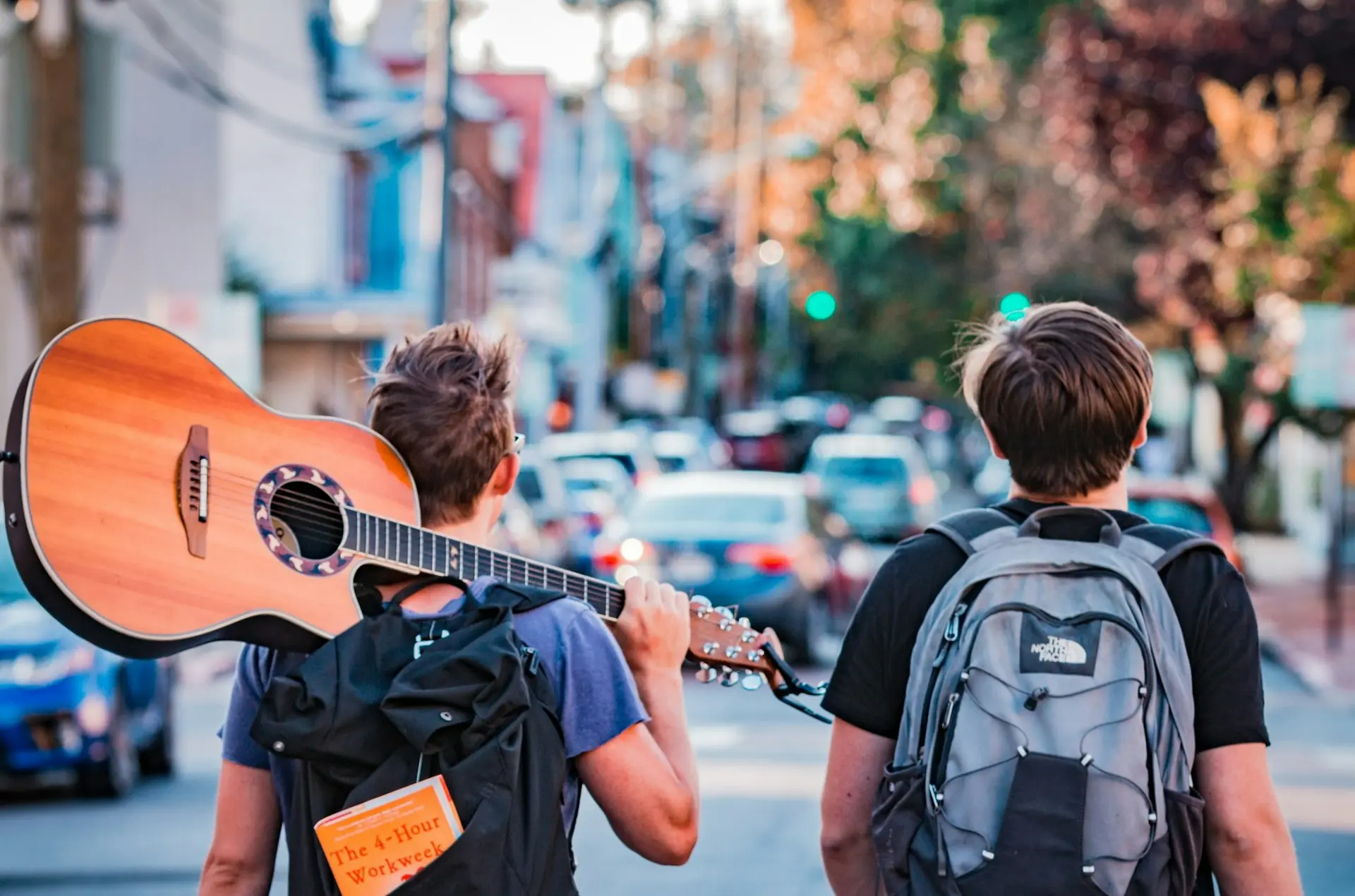 two man carrying backpacks during daytime